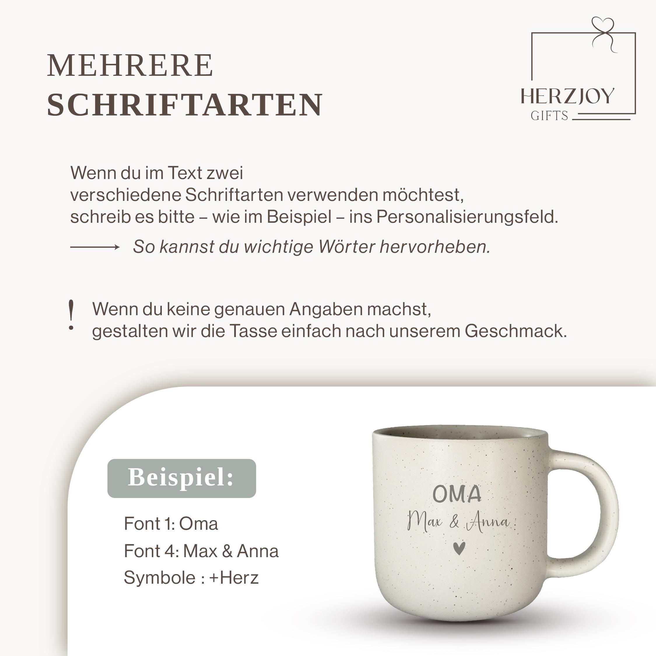 May include: Two ceramic mugs, one black with white speckles and the word "SCHWARZ", the other white with speckles and the word "WEIB". Both mugs have a tan-coloured base and a curved handle. The mugs are stacked on top of each other.