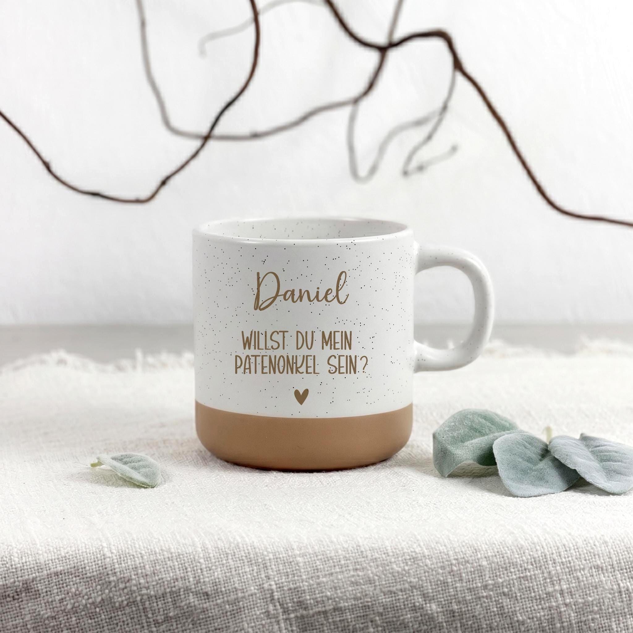 Personalisierte Tasse Patenonkel mit Name und Herzmotiv als Geschenk zur Taufe oder Patenschaftsfrage. Diese hochwertige Keramiktasse ist eine besondere Überraschung für den zukünftigen Patenonkel und eine schöne Erinnerung an seine wichtige Rolle im Leben des Kindes.