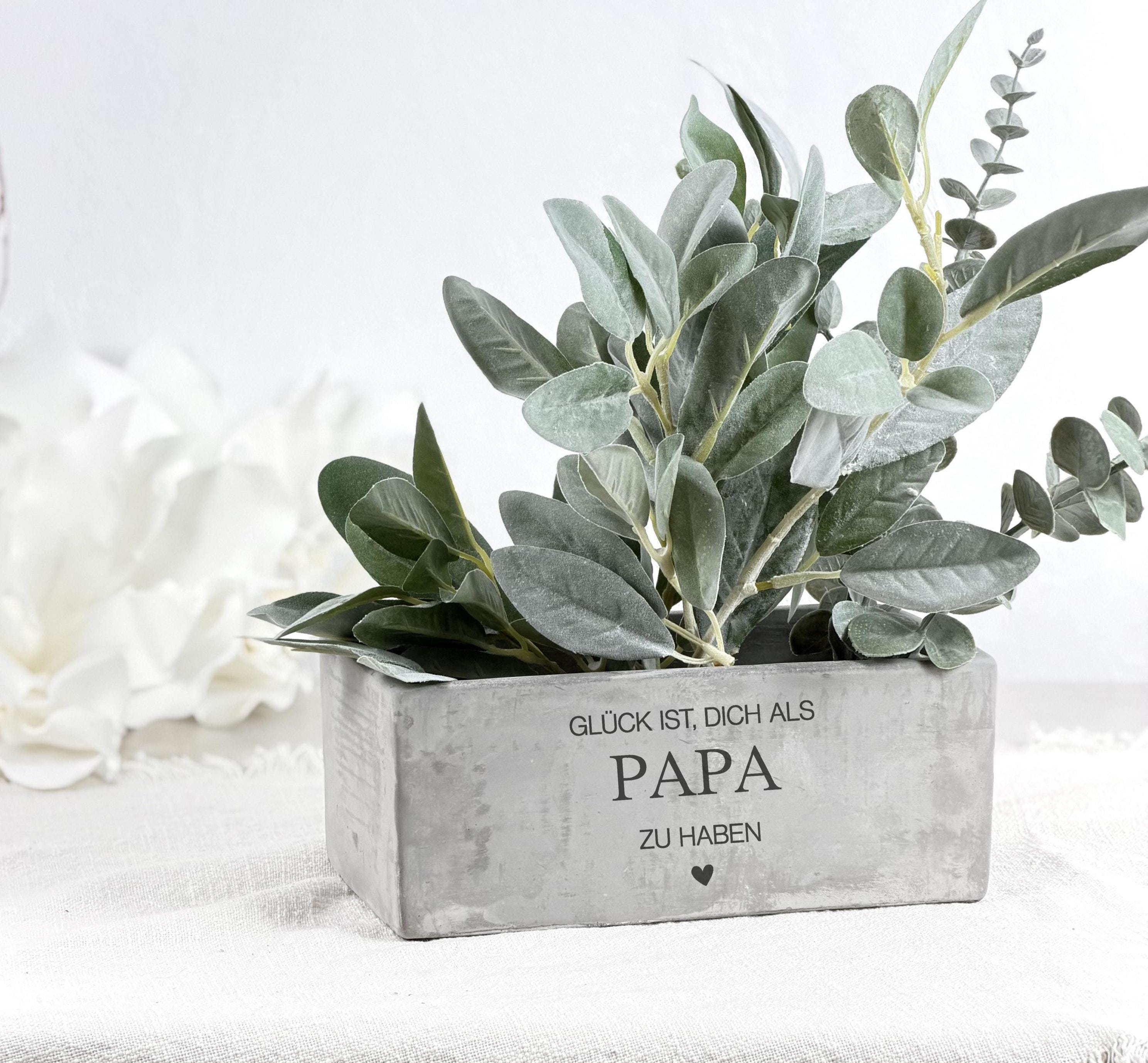 Geschenk für Papa als Blumentopf in Betonoptik mit Gravur. Dieses Vatertagsgeschenk ist ideal als Papa Geschenkidee oder Geburtstagsgeschenk Papa personalisiert. Der Blumentopf eignet sich für Kräuter, Blumen oder Sukkulenten und bringt Stil und Persönlichkeit in jedes Zuhause.